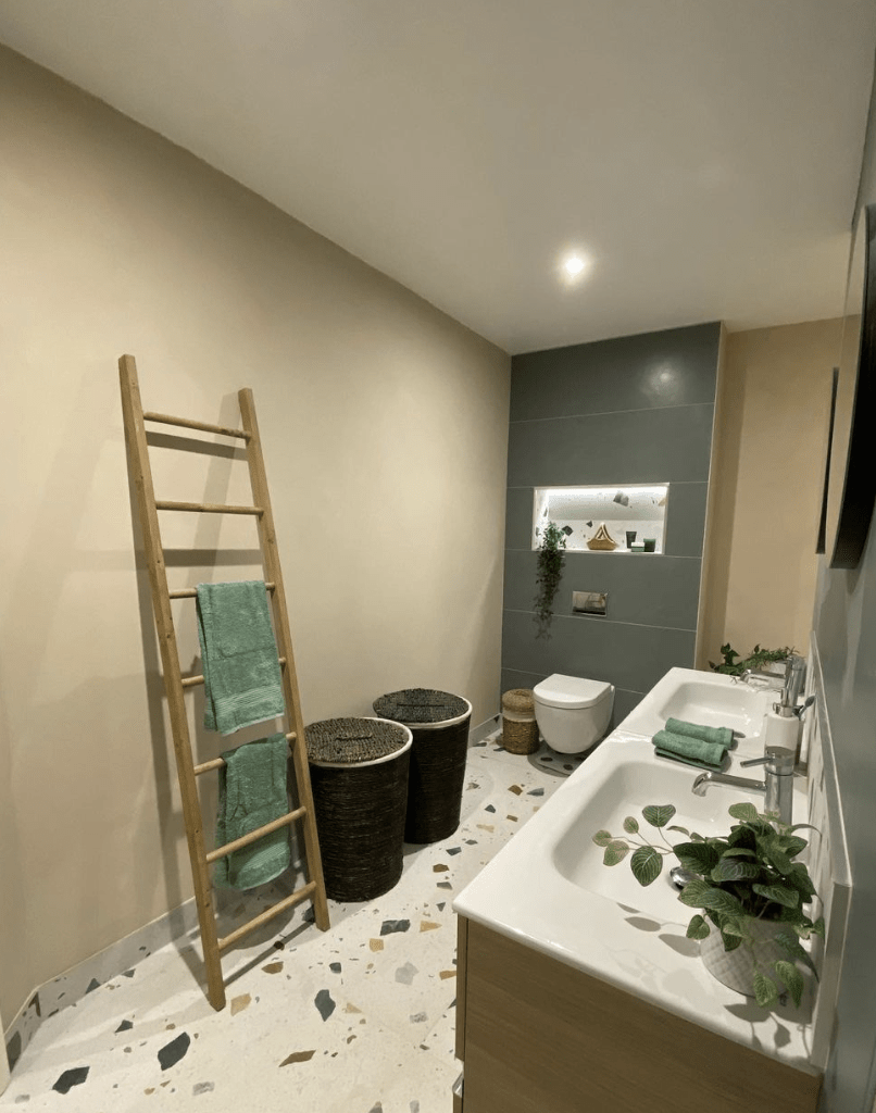 terrazzo floor in bathroom with towel ladder double vanity