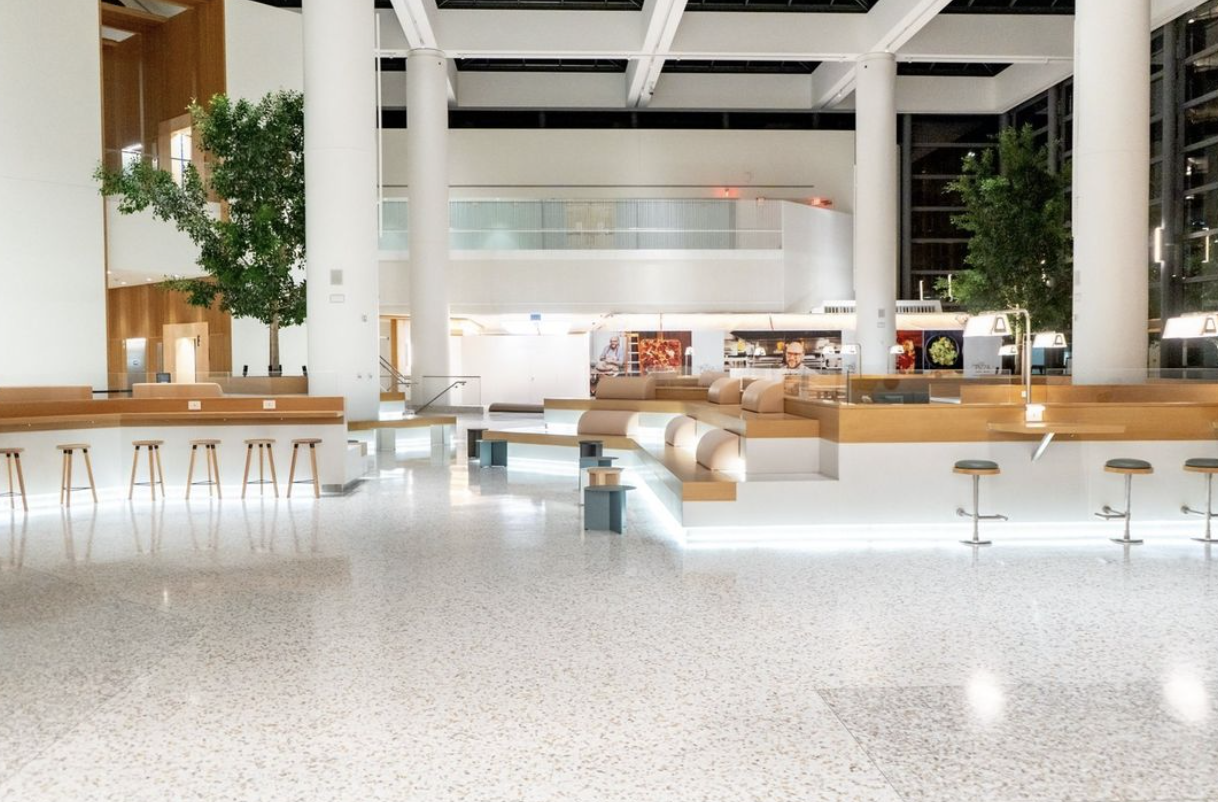 terrazzo floor in large open atrium space with bar and stools