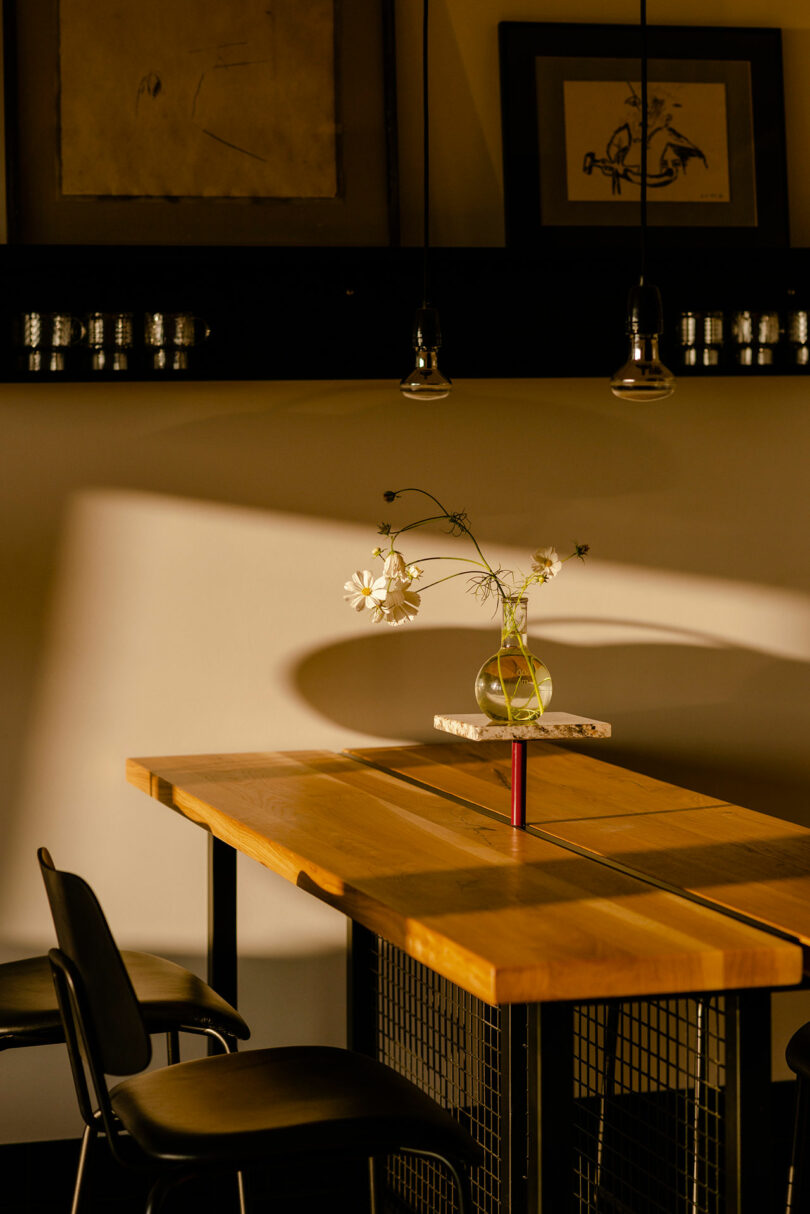 partial view of modern kitchen interior with wood and black table shot at twilight
