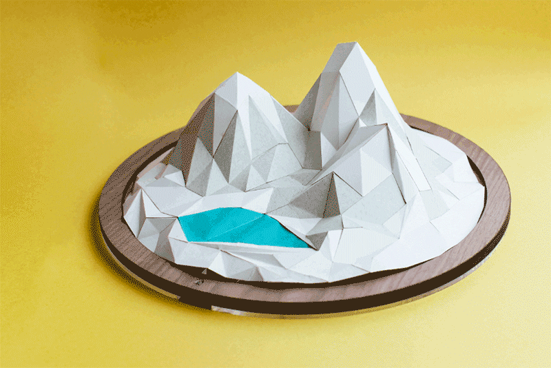 animated gif of a revolving paper mountain on a yellow background