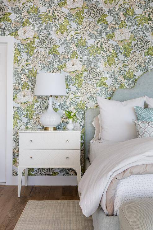Bedroom features a white rippled gourd lamp on a white geometric nightstand and a Heather gray bed on green and yellow botanical wallpaper.