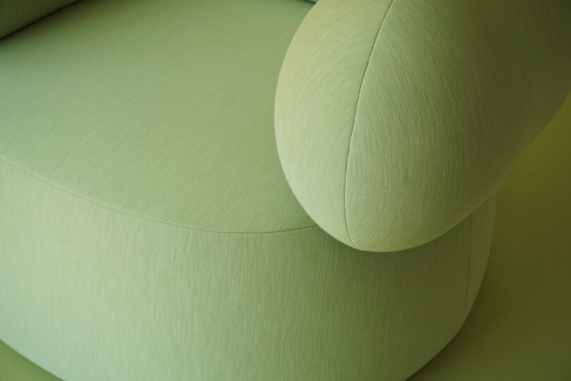 detail of green single lounge chair with armrests
