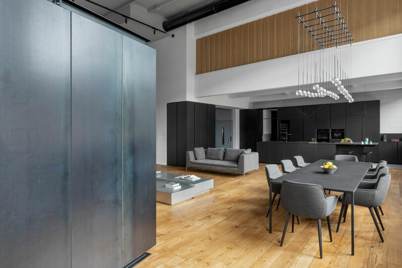 Angled interior shot of modern industrial loft showing living room kitchen and dining space