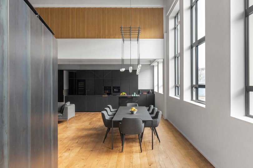 Angled interior shot of modern industrial loft showing living room kitchen and dining space