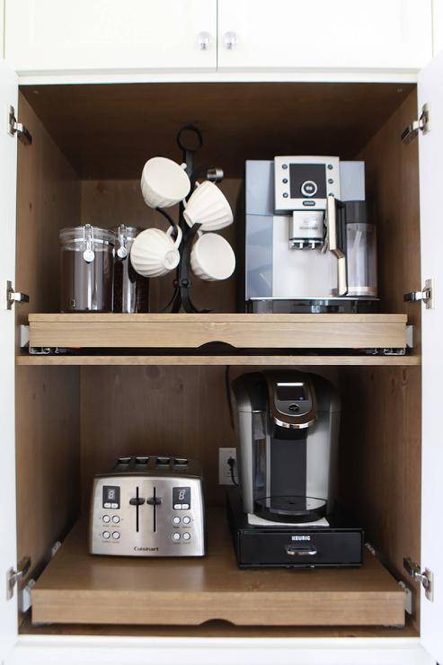 Coffee cabinet is fitted with pull out shelves.