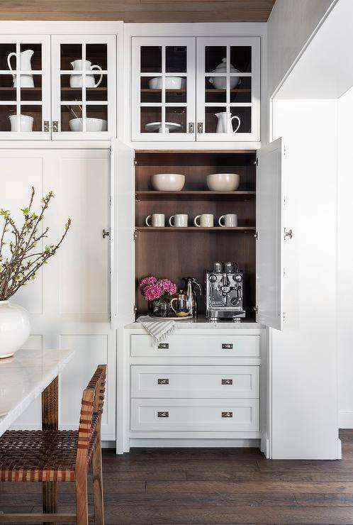 Kitchen features a coffee station in a white cabinet with walnut trim.