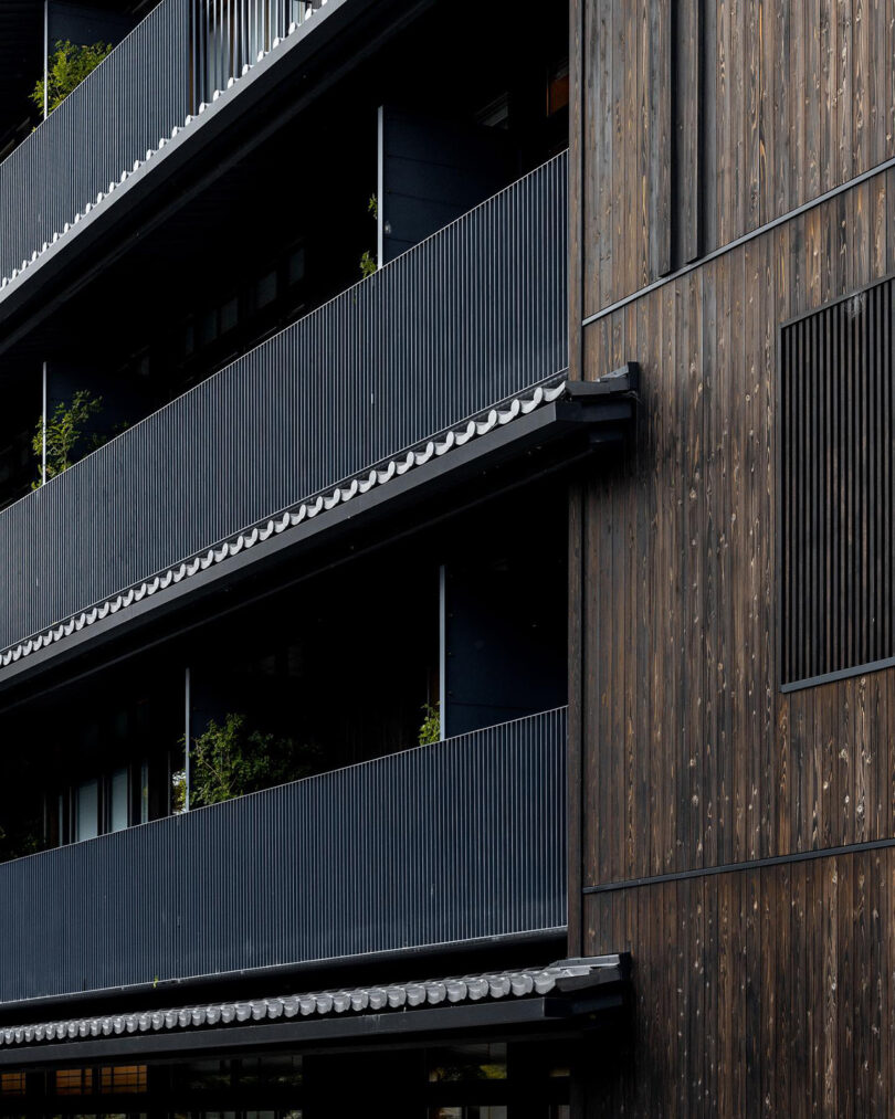 Detail of Shinmonzen hotel's balcony lined and wood clad exterior.