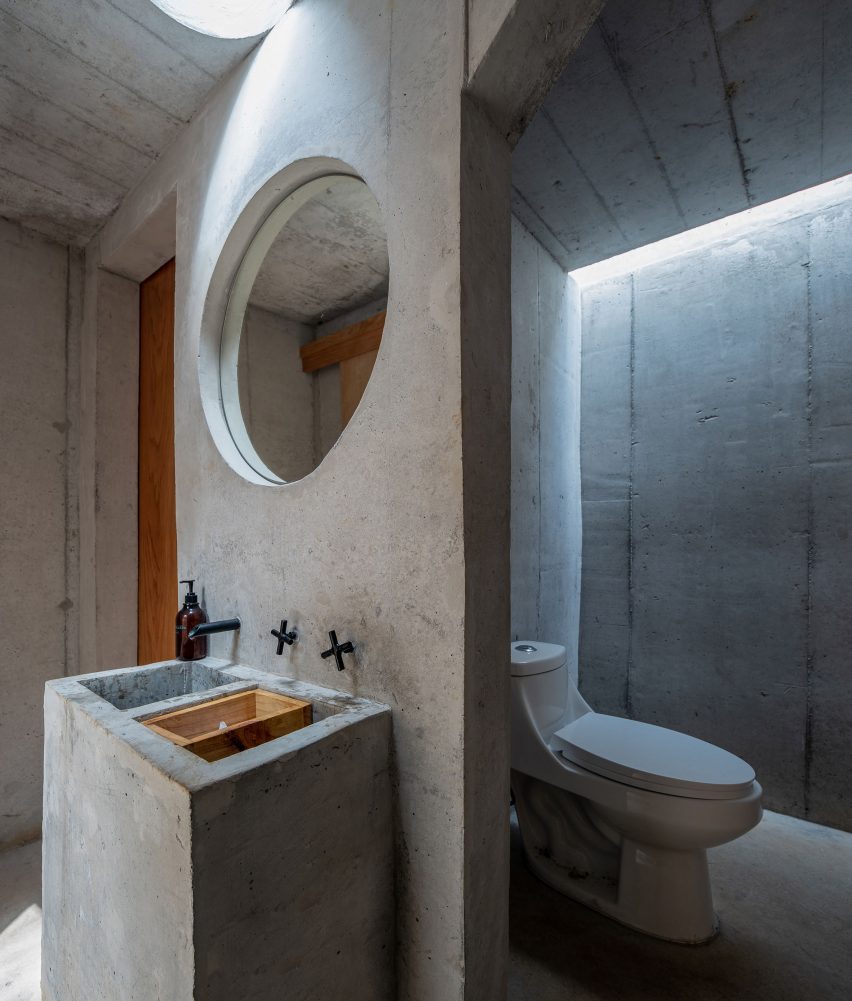 Concrete cube with a bathroom inside
