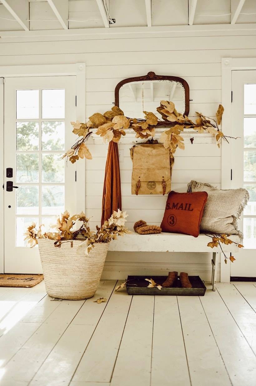 Rustic fall entryway with leaves.