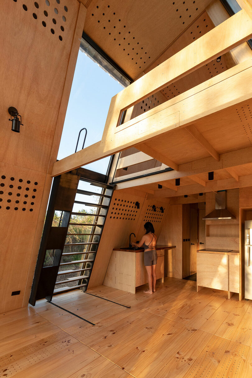 angled interior view of modern cabin with slanted wood walls and minimalist decor
