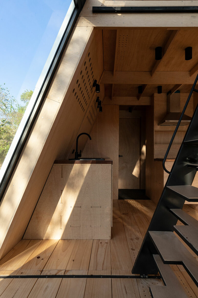 interior view of modern cabin with slanted wood walls and minimalist decor