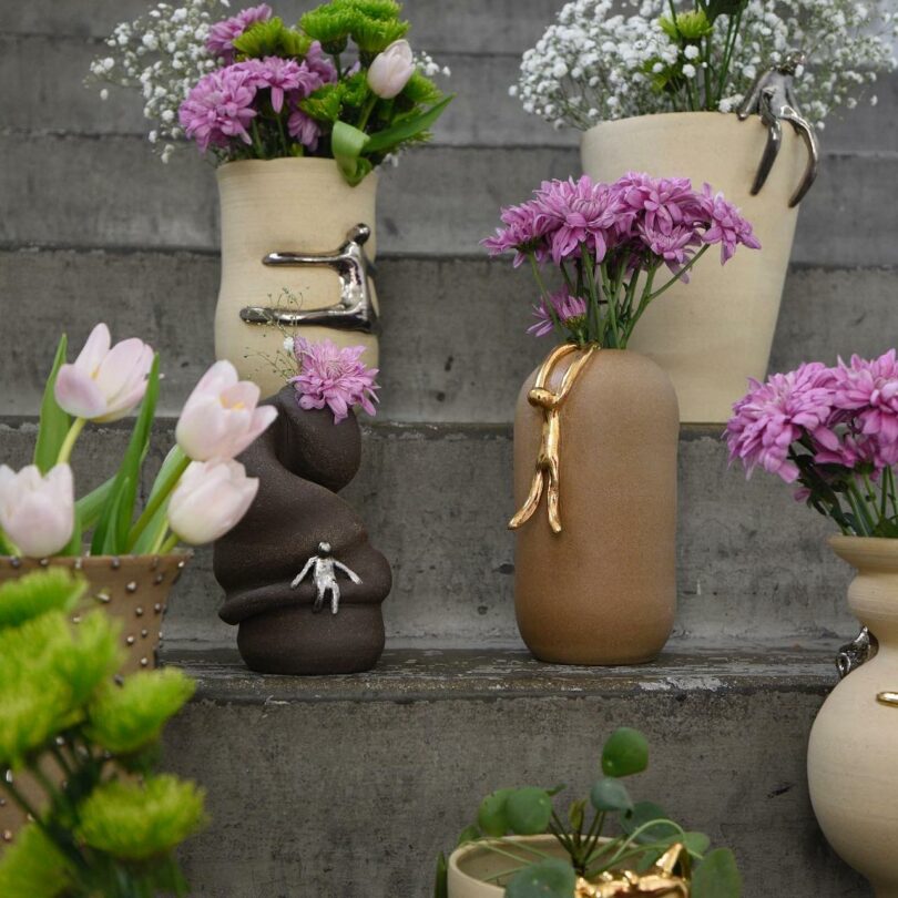 Various Lulu Pots ceramics with purple flowers inside