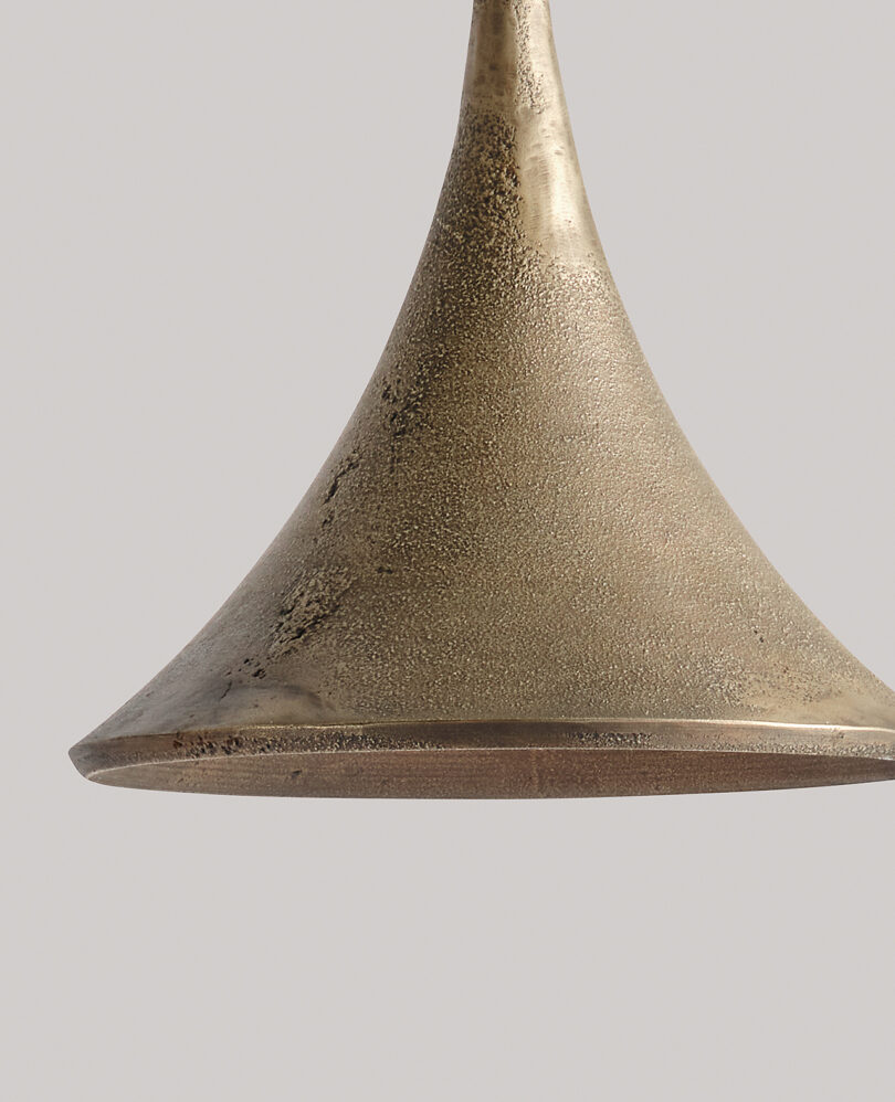 detail of gold-hued lighting pendant