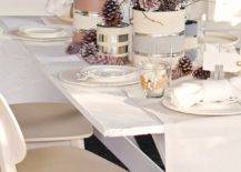 painted paint cans with pinecones and sticks on white Christmas tablescape