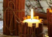 cinnamon sticks wrapped around white candles
