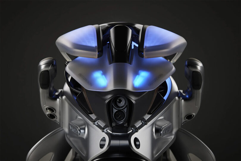 Front view of MOTOROiD 2 electric motorcycles blue LED illuminated ambient lighting and view of the motorcycle's front headlights.