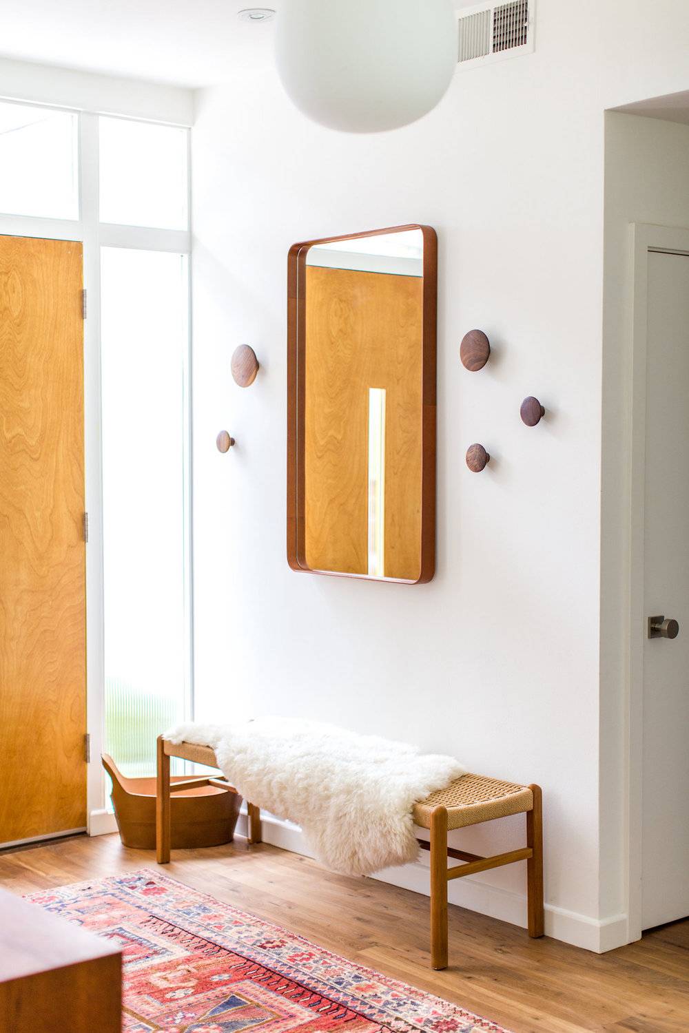 Simple entryway with a natural wood bench.