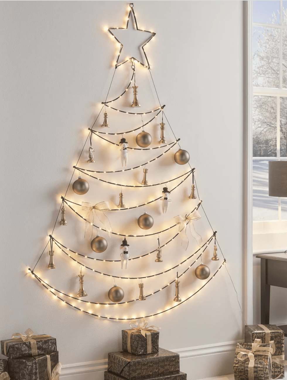 string lights on wall in shape of christmas tree with ornaments