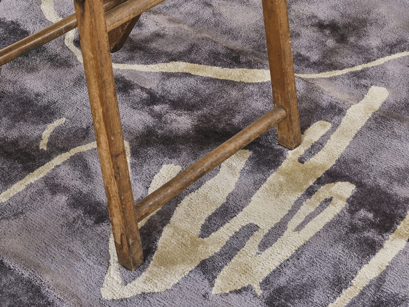 detail of dining chair on abstract rug