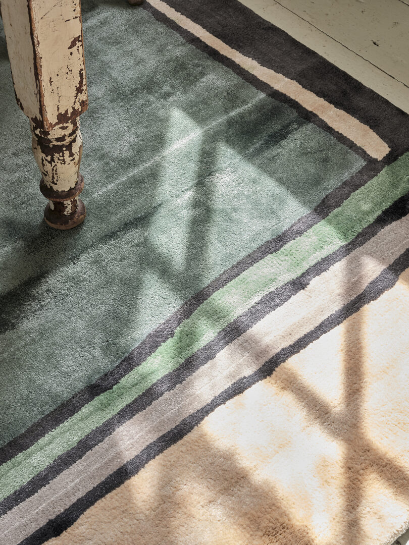 detail of blue, green, and cream colored rug