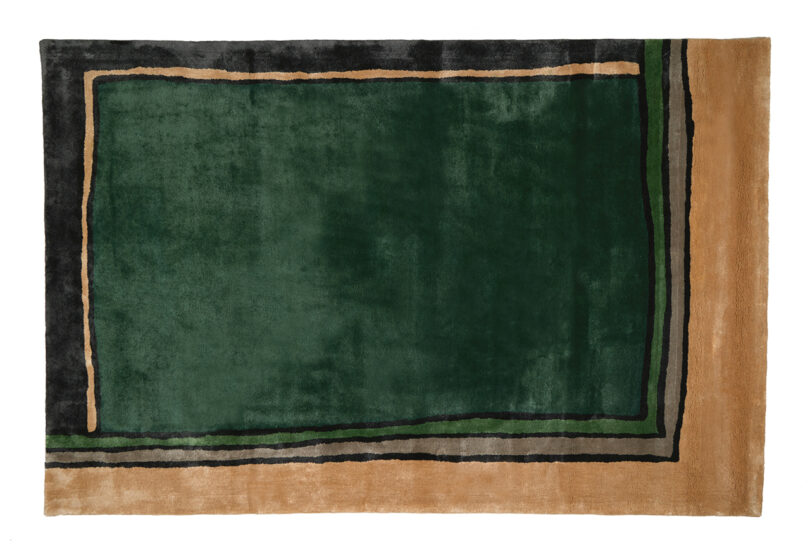 dark green and tan abstract rug on white background