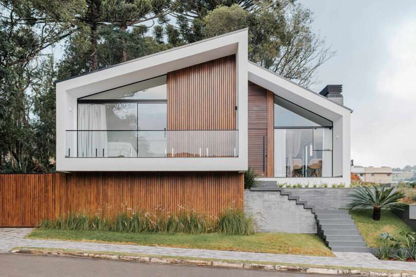 modern home with angular exterior with vertical wood slat cladding and gray details