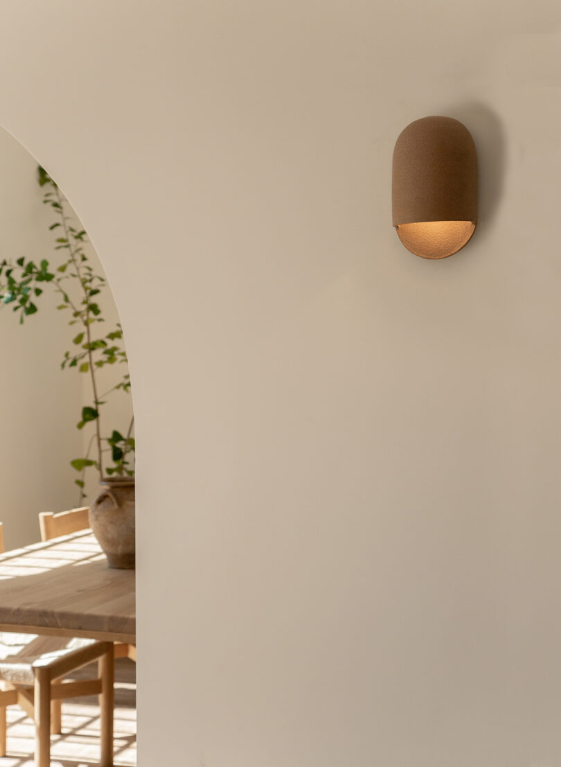 brown domed ceramic sconce hanging on an interior wall of a home