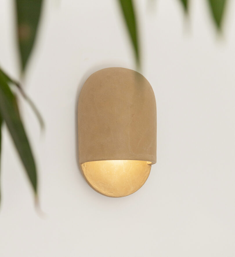 beige domed ceramic sconces hanging on a white wall