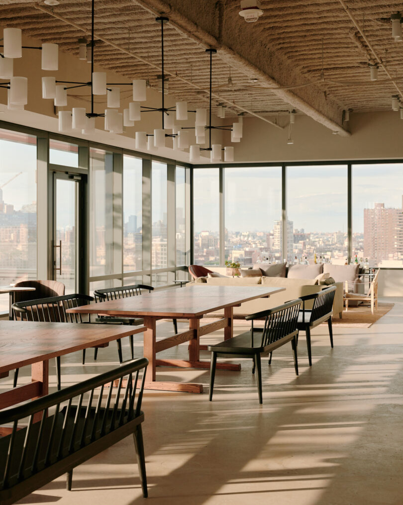 tables with chairs around them in high-rise office