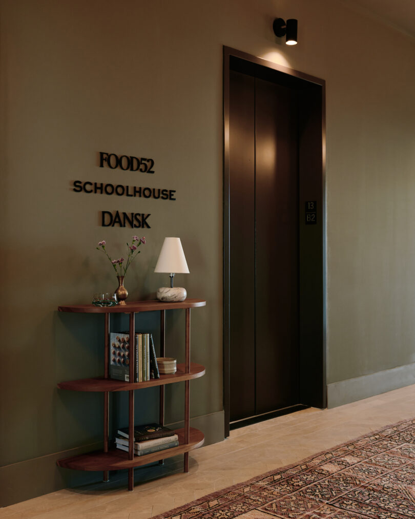 elevator entrance next to a brown shelf