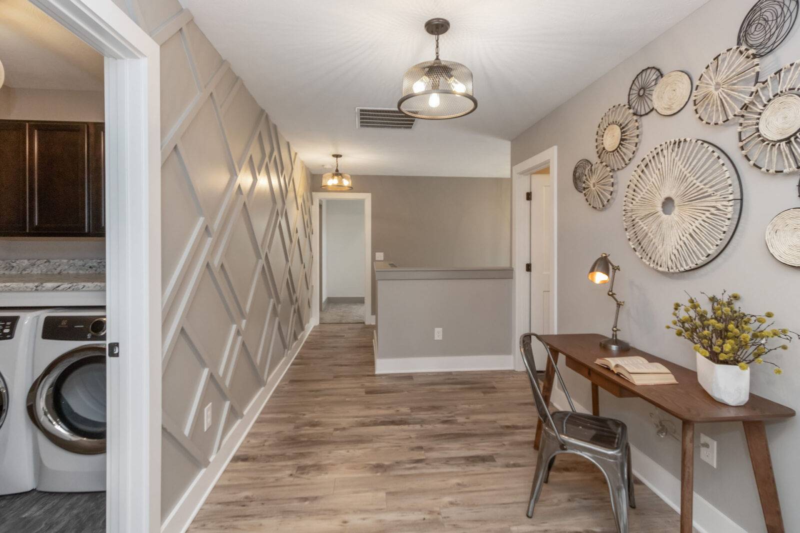 Geometric art wood accent wall in a hallway with a mini office working area.