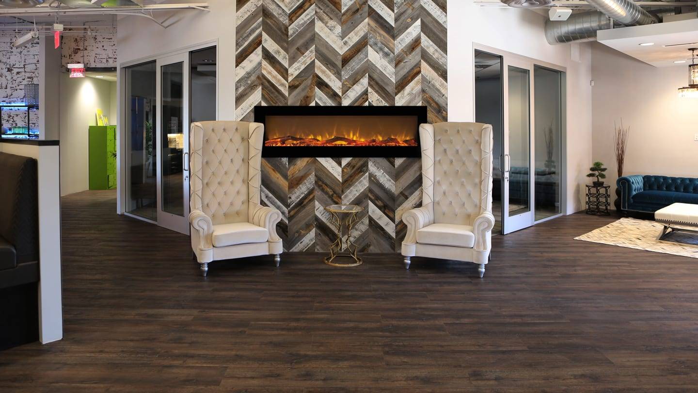 Mixed Weathered wood accent wall fronted by two white chairs.