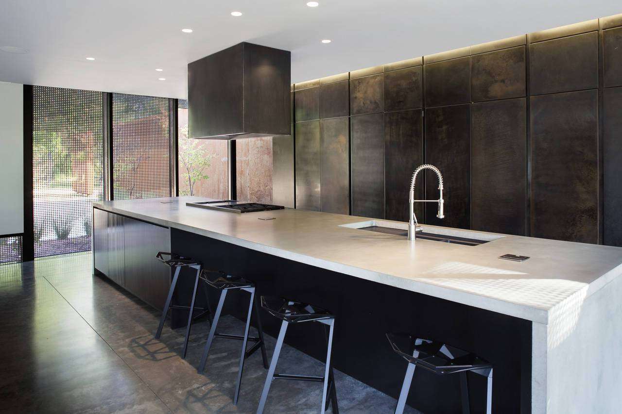 Black stained wall in a modern dark kitchen.