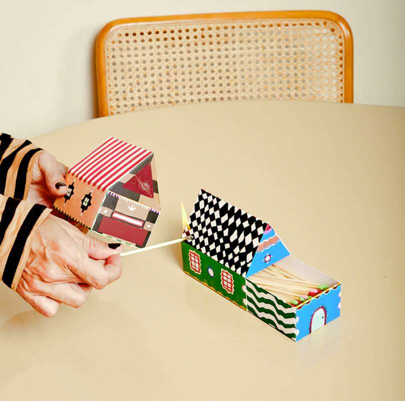 angled down view of table with two house-shaped boxes of colorful matches.