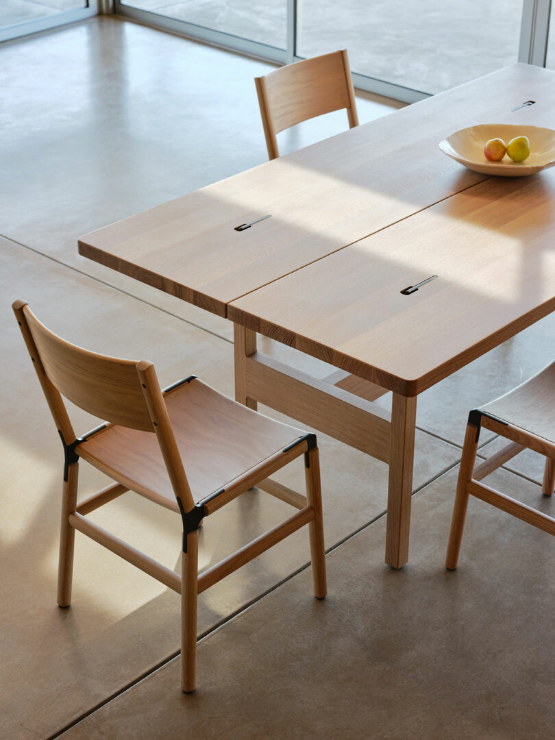 Detail of table hardware and chairs in sunlight.