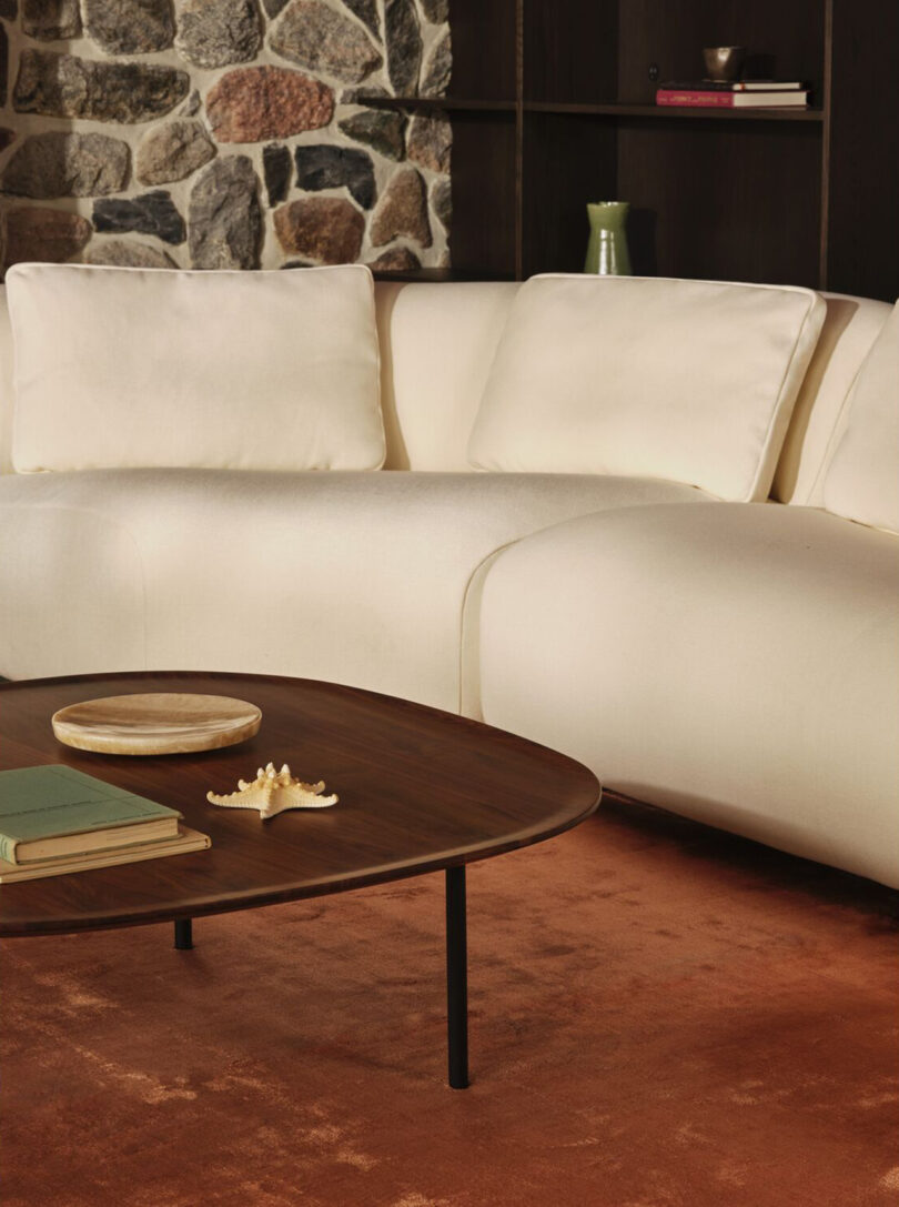 styled living space with a cream colored sectional sofa and coffee table