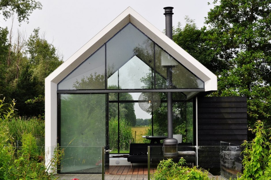 Up close view of a modern tiny home that features large glass windows on both sides.