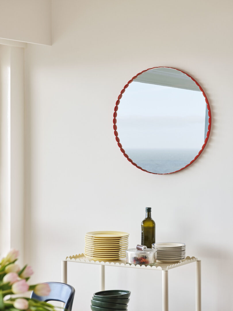 modern trolley under scalloped mirror