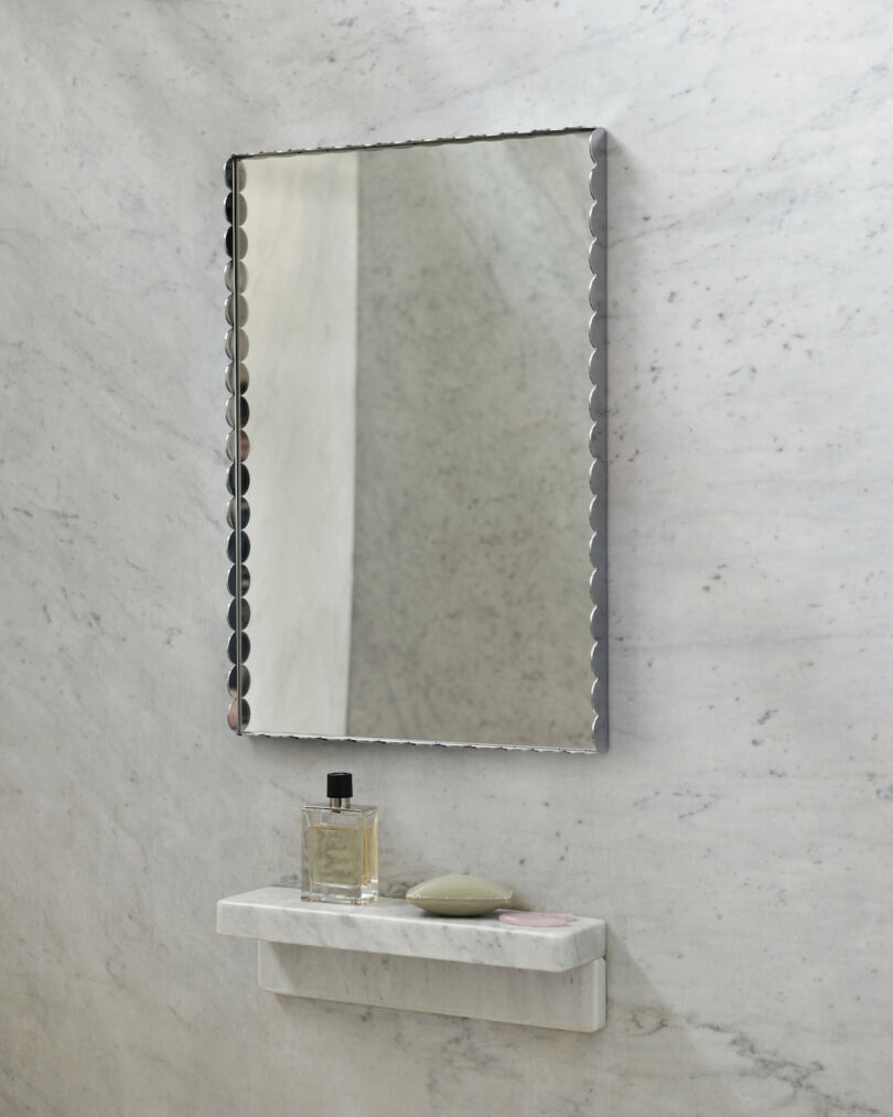 mirror finish scalloped mirror in marble bathroom