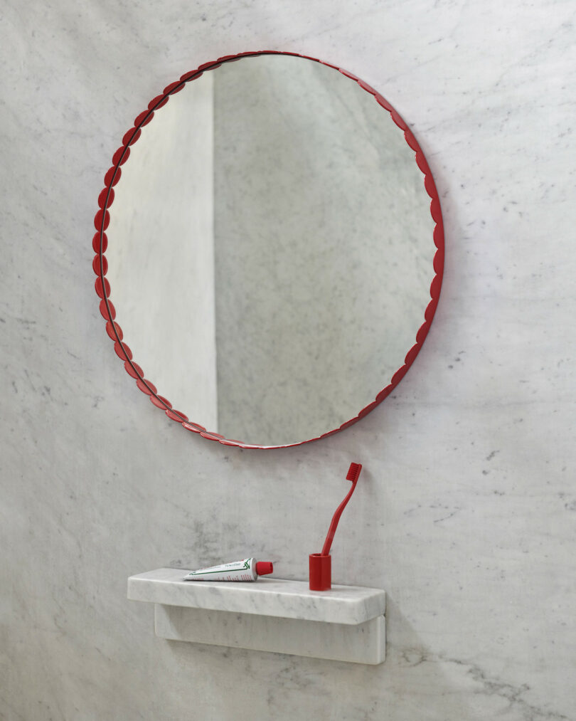 red mirror in marble bathroom