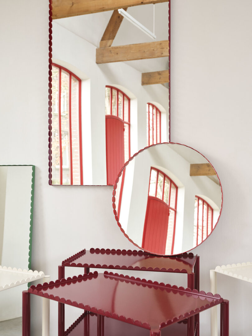red trolleys next to scalloped mirrors