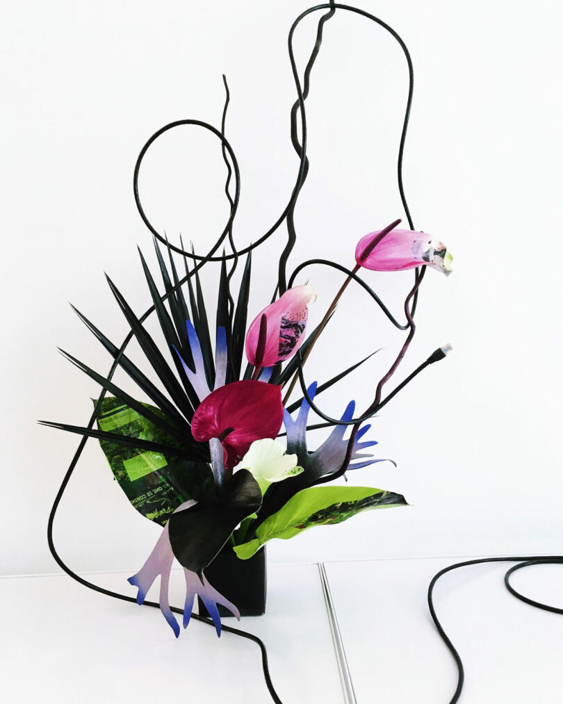Contemporary floral arrangement with painted leaves.