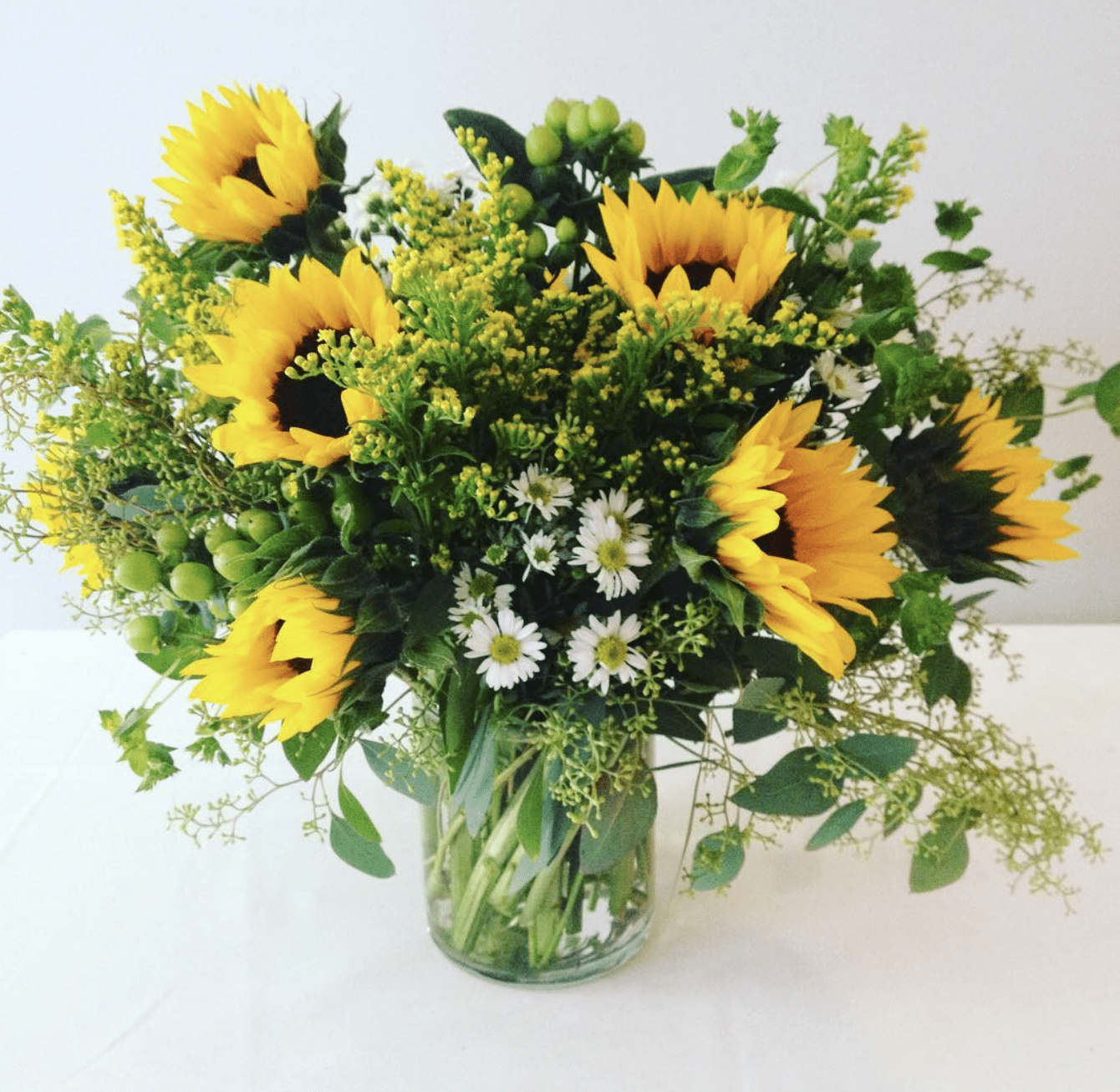 Sunflower arrangement in a glass vase.