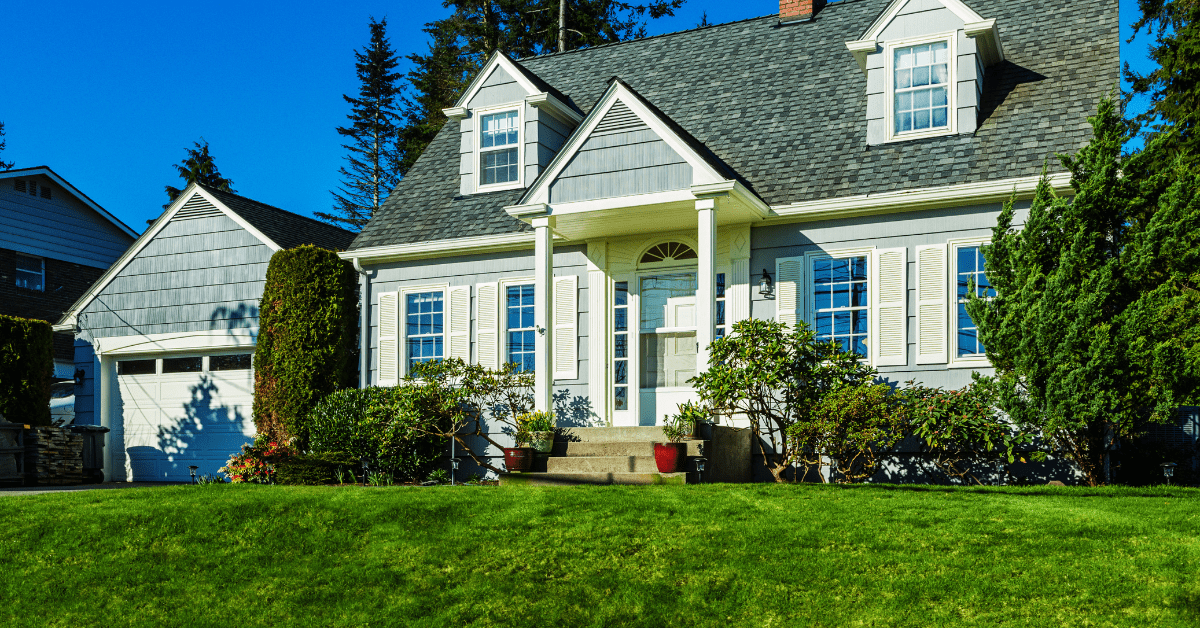 Modern Cape Cod house with detached single door garage.