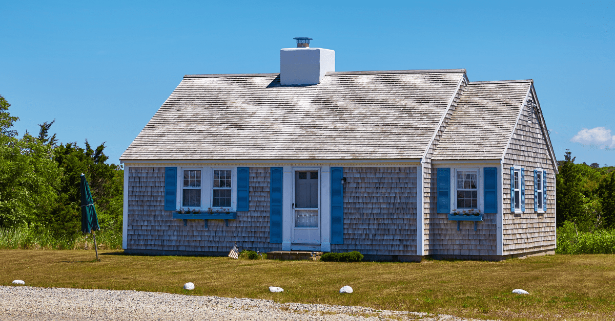 Small Cape Cod house with blue accents.