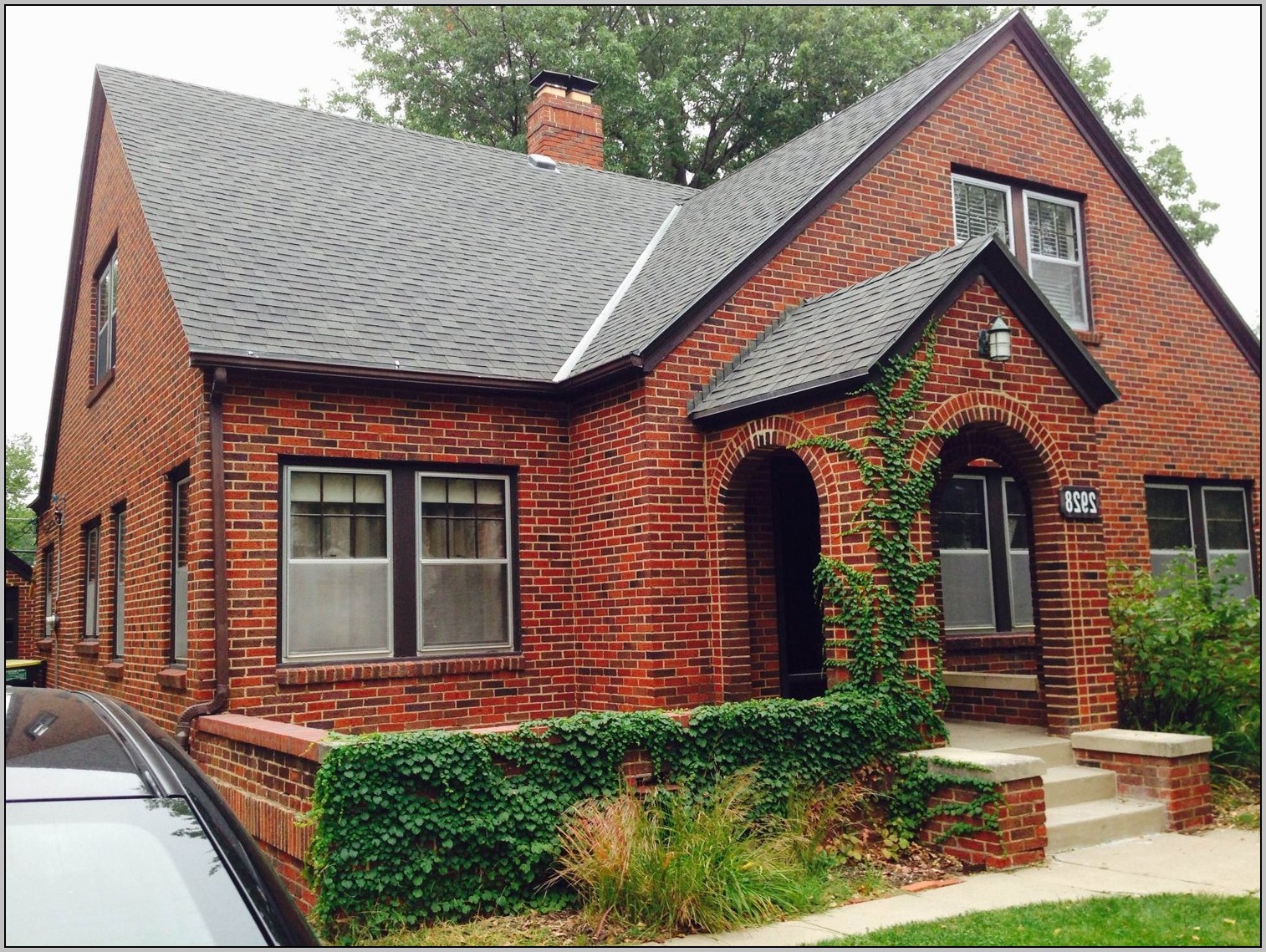 One-story red brick house with an awning by the front door.