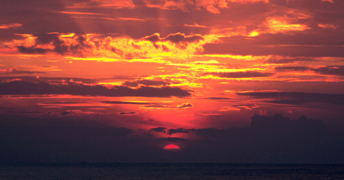 Sunset behind clouds.