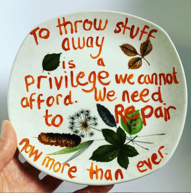 hand-painted plate reading "To throw stuff away is a privilege we cannot afford. We need to repair more now than ever."