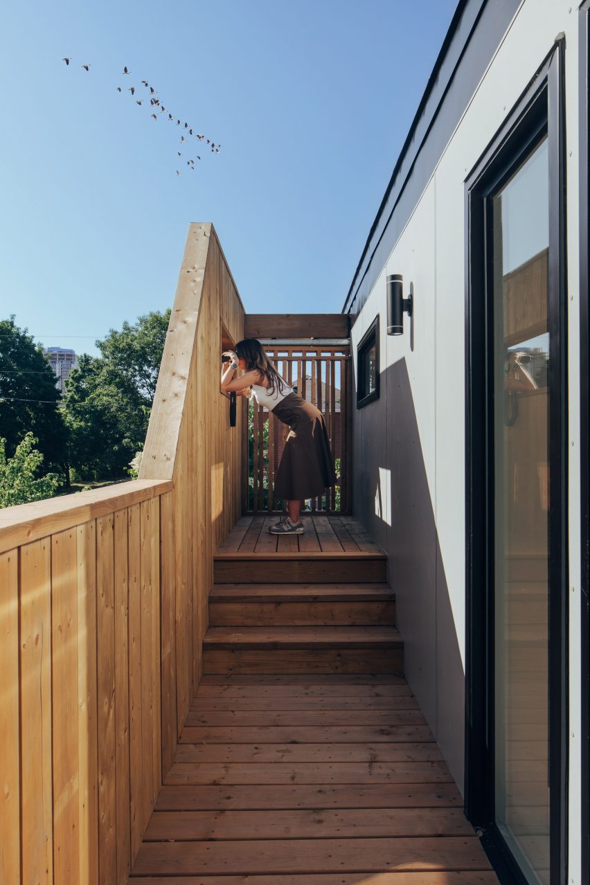 woman watching birds from viewing platform