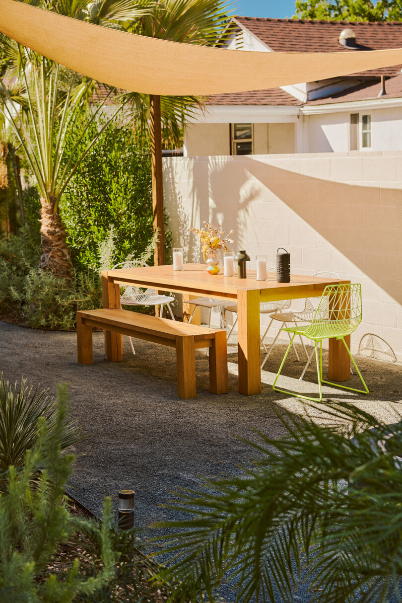 outdoor space with light wood dining table and bench